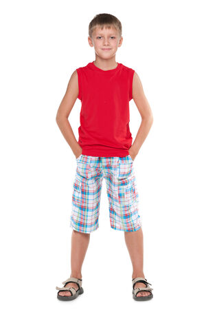 A portrait of a cute young boy in a red shirt on the white の写真素材