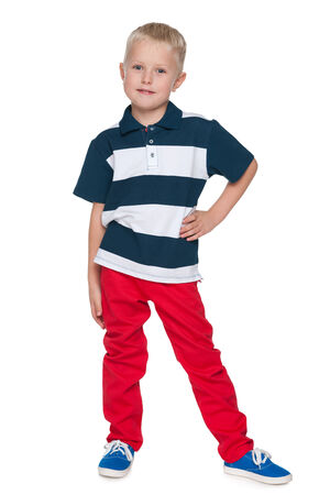 A portrait of a fashion little boy in the red pants on the white の写真素材