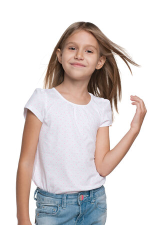 A portrait of a smiling little girl with flowing hair on the white の写真素材