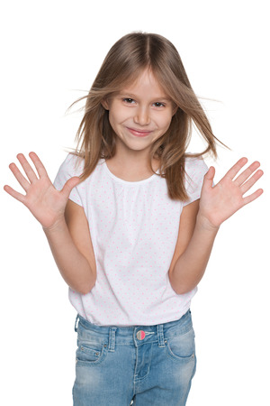 A portrait of an adorable joyful little girl against the white の写真素材
