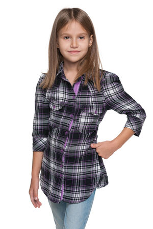 A fashion young girl is standing on the white の写真素材