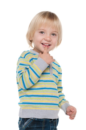 A portrait of a curious little boy on the white の写真素材