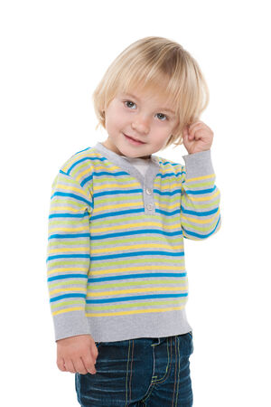 A portrait of a curious little boy against the white の写真素材