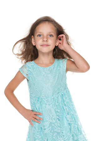 A portrait of a lovely pensive little girl against the white の写真素材