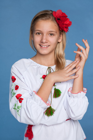 A cheerful preteen Ukrainian girl on the blue の写真素材