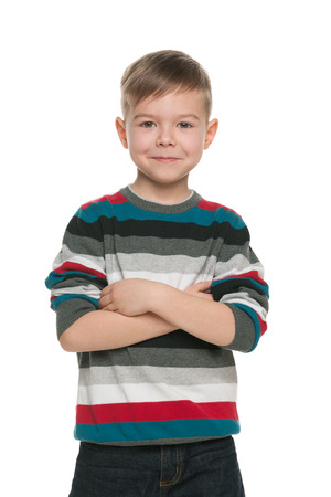 A handsome young boy stands on the white の写真素材
