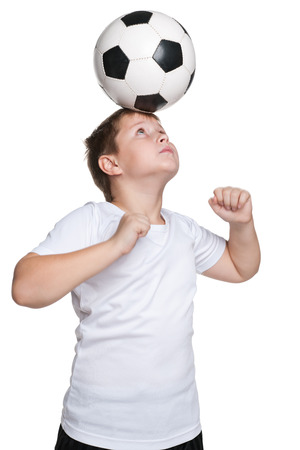 A portrait of dexterous footballer with a ball on the white の写真素材