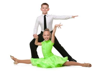 Happy boy and girl are dancing against the white backgroundの写真素材