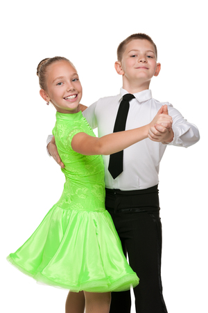 Boy and girl are dancing together against the white backgroundの写真素材