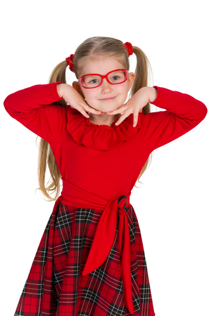 A portrait of an adorable little girl in glassess on the white backgroundの写真素材