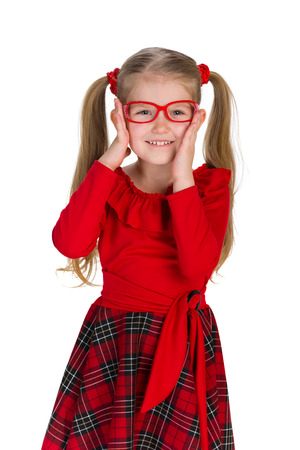 A portrait of a fashion little girl in glassess the white backgroundの写真素材