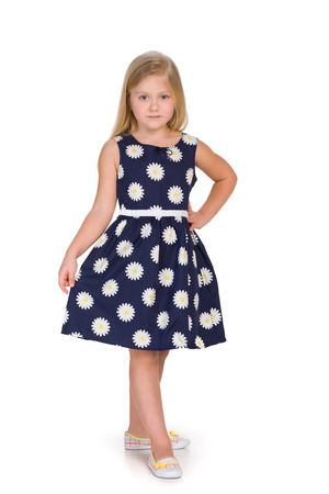 A pretty blond girl is standing on the white backgroundの写真素材