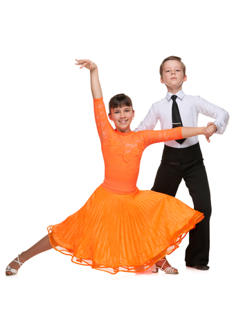Young boy and girl are dancing on the white backgroundの写真素材