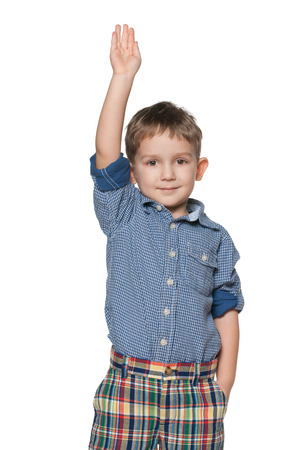 A portrait of a little boy making greeting gestureの写真素材