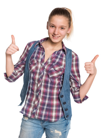 A pretty teen girl holds her thumbs up against the white backgroundの写真素材