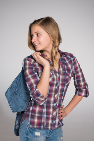 An adorable fashion teen girl looks backの写真素材