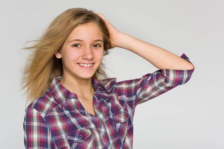 An adorable teen girl against the gray backgroundの写真素材