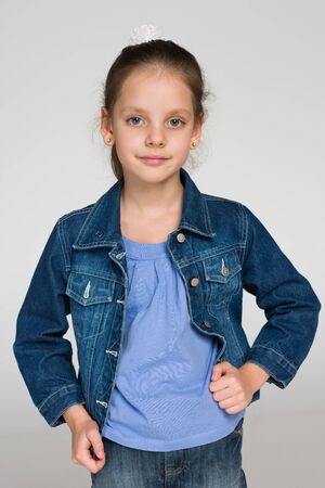 A portrait of an adorable little girl against the gray backgroundの写真素材