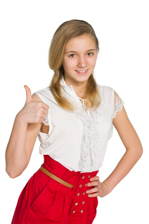 A teen girl holds her thumb up against the white backgroundの写真素材