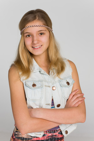A portrait of an adorable blonde teen girl on the gray backgroundの写真素材
