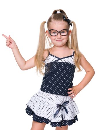 A little girl shows her finger to the side on the white backgroundの写真素材