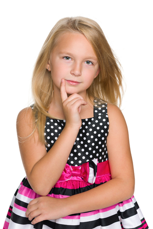 A portrait of a thinking blonde little girl on the white backgroundの写真素材