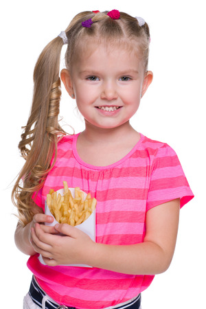 A smiling little girl with fries on the white backgroundの写真素材