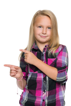A blonde young girl shows her fingers to the sideの写真素材
