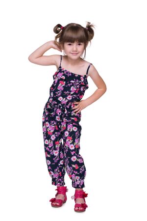 A joyful preschool girl is standing on the white backgroundの写真素材