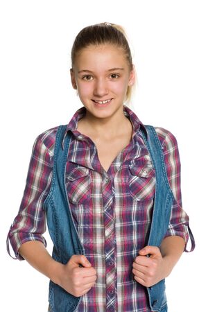 A blondee teen girl stands against the white backgroundの写真素材
