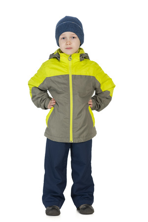 A portrait of a smiling little boy in a winter jacket against the white backgroundの写真素材
