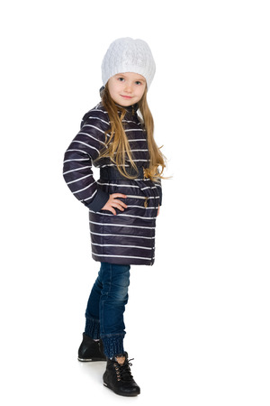 A portrait of a pretty little girl in the winter clothes against the white backgroundの写真素材