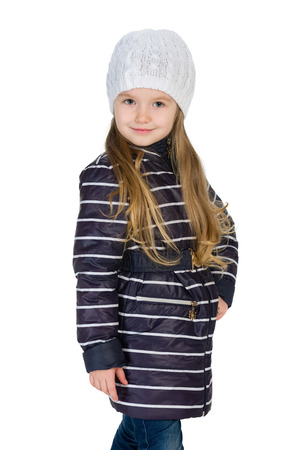 A portrait of a fashion little girl in the winter clothes against the white backgroundの写真素材