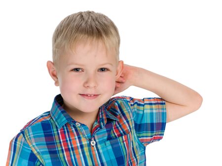 A closeup portrait of a little blond boy on the white backgroundの写真素材