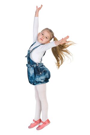 A lovely little girl jumps against the white backgroundの写真素材