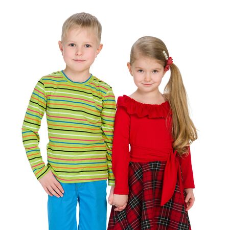 Two fashion children are standing together against the white backgroundの写真素材