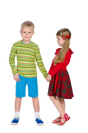 Two fashion children stand together on the white backgroundの写真素材