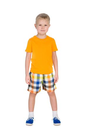Portrait of a cute little boy in a yellow shirt on the white backgroundの写真素材