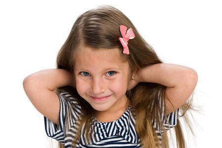 A portrait of a pretty happy little girl against the white backgroundの写真素材