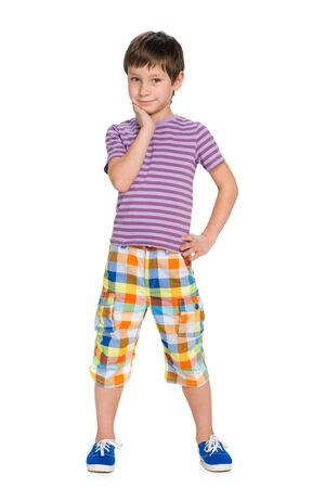 A portrait of a pensive cute young boy on the white backgroundの写真素材