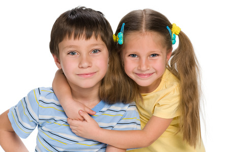 A closeup portrait of two little children together on the white backgroundの写真素材