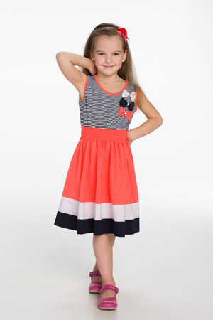 A portrait of a fashion smiling little girl on the gray backgroundの写真素材