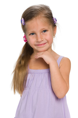 A closeup portrait of an adorable little girl on the white backgroundの写真素材
