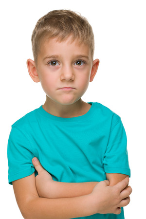 A portrait of a pensive preschool boy against the white backgroundの写真素材