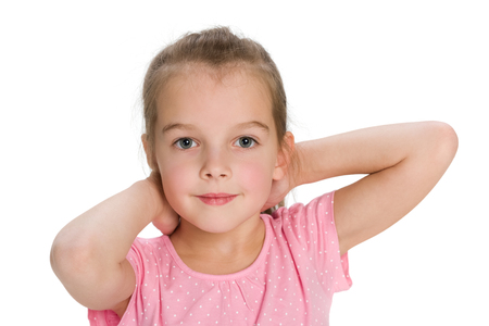 A thoughtful pretty little girl on the white backgroundの写真素材