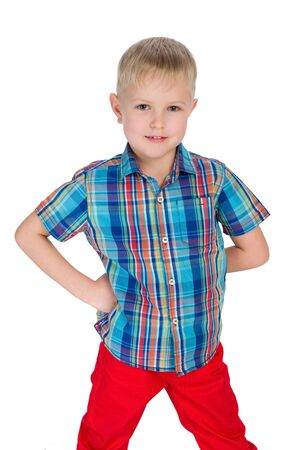 A handsome little boy in the red pants on the white backgroundの写真素材