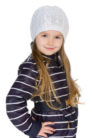 A portrait of a pretty little girl in the winter clothes against the white backgroundの写真素材