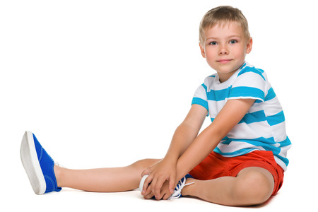 A profile portrait of a cute little boy on the white backgroundの写真素材