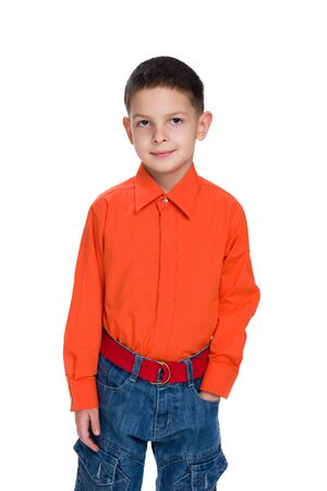 A portrait of a smiling young boy in a red shirt on the white backgroundの写真素材