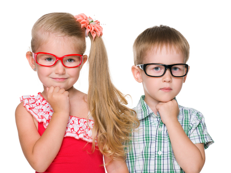 A portrait of two clever little children on the white backgroundの写真素材